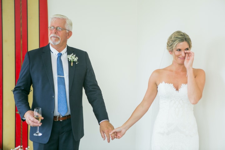Father of the bride with his teary daughter on the wedding day